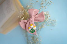 Load image into Gallery viewer, An aesthetic zoomed in image of a Daisy delight knot Hairclip for girls. Hair Accessories on a light blue background.