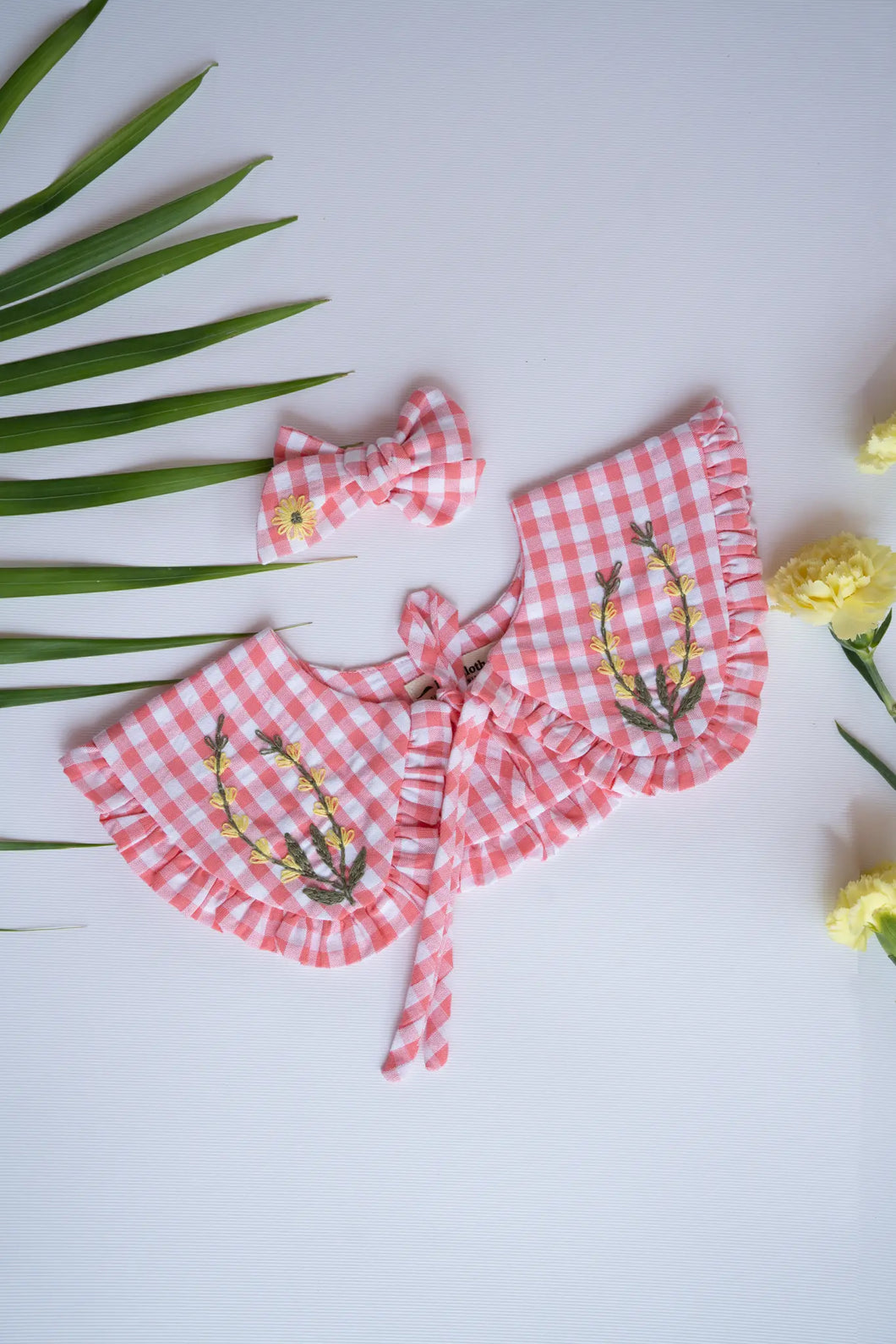 A Detachable Collar and Hair Bow set - pink Check, hair accessories kept on a white surface