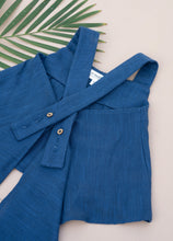 गैलरी व्यूवर में इमेज लोड करें, A close backside view of a beautiful Pure Cotton Indigo coloured Pleated Top for kidswear placed on a peach background with a leaf aside