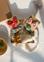Load image into Gallery viewer, Beautiful brown box containing some Christmas hair accessories with some toys, placed on a white background