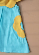 Load image into Gallery viewer, A beautiful dress with petal detailing's around the neck and pockets kept upon a peach background.