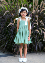 Load image into Gallery viewer, A girl wearing elegant and beautiful secret fairy pocket dress with white headband posing in front of plants.
