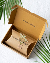 गैलरी व्यूवर में इमेज लोड करें, A brown gift box with wrapped gift box knotted with thread along with a flower with white background with some leaves aside it.