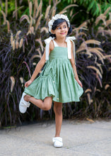 Load image into Gallery viewer, A girl posing by wearing ruffled white headband near a plant.