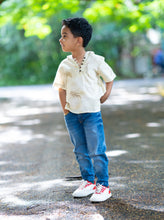 Load image into Gallery viewer, A kid posing in the middle of the street wearing a unisex hooded kurta eco-printed using silver oak leaves.