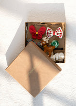 Load image into Gallery viewer, Beautiful brown box containing some Christmas hair accessories with some toys, placed on a white background