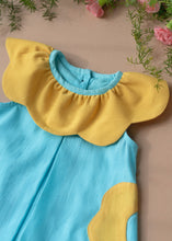 Load image into Gallery viewer, A beautiful dress with petal detailing's around the neck and pockets kept upon a peach background with some flowers aside.