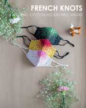 Load image into Gallery viewer, A colourful French knots organic cotton adjustable masks with some toy and flower aside.