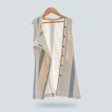 गैलरी व्यूवर में इमेज लोड करें, A beautiful white A-line shift dress with flattering vertical blue stripes and laced hemline is hanged using hanger.