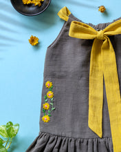 गैलरी व्यूवर में इमेज लोड करें, A beautiful dress with extra-long bow tie strap kept on a blue floor with some leaf, flower and needle aside.