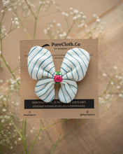 Load image into Gallery viewer, A cute butterfly hair accessories tied on a brown card placed upon a flower.

