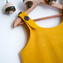 Load image into Gallery viewer, A beautiful deep yellow extendable shift dress hanged in hanger.
