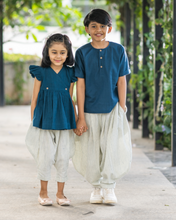गैलरी व्यूवर में इमेज लोड करें, A young girl wearing elegant blue flutter sleeve top and cream balloon pant and young boy wearing blue and cream balloon pant posing together.
