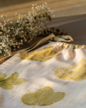 गैलरी व्यूवर में इमेज लोड करें, A cute baby girl dress made of eco-printed Indian maple leaves on it along with some flower aside.