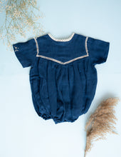 Load image into Gallery viewer, An image of an Indigo coloured cotton Romper for kids against a light blue background.
