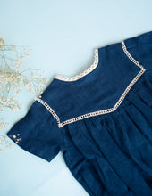 Load image into Gallery viewer, A magnified image of the indigo coloured cotton romper on a blue background.
