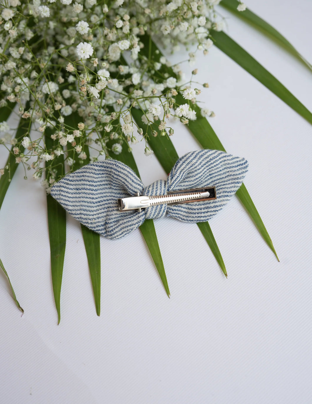 An aesthetic of Embroidered Headbands | Cotton | Indigo Stripe | Infant and Girls on a white surface