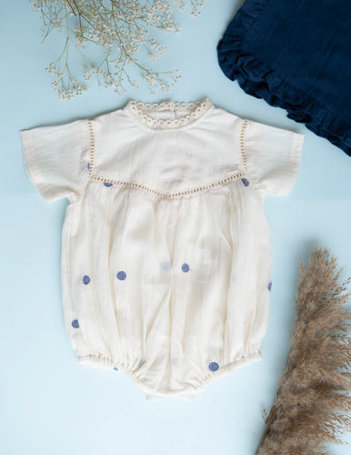 A beautiful image of Baby Girl Romper and Detachable Vest | Cotton Jamdani | Polka Dot against a blue surface 