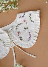 Load image into Gallery viewer, A beautiful detachable victorian style collar with subtle hand embroidery for kids kept on light peach background with some flowers aside.
