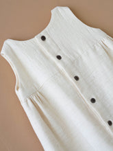 Load image into Gallery viewer, A backside of an elegant Vintage kora white frock kept upon a peach background.
