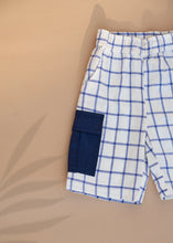 Load image into Gallery viewer, A unisex organic cotton baby clothes pant with Patch Pocket with indigo checkmate design kept on a beige background
