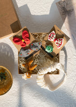 Load image into Gallery viewer, Beautiful brown box containing some Christmas hair accessories with some toys, placed on a white background
