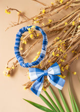 Load image into Gallery viewer, A beautiful cotton handmade blue headbanded and a bow for kidswear kept upon dried flowers.
