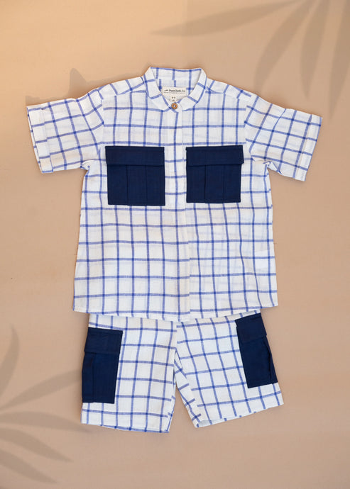 A set of Handwoven Cotton Co-ord set with Patch Pocket  kidswear with indigo checkmate design kept on a beige background