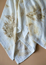 Load image into Gallery viewer, A beautiful muslin baby swaddle with silver oak leaves eco printed on it.
