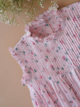 Load image into Gallery viewer, A beautiful pink fairy floral dress with frills at the neck kept upon a peach background with some flowers aside.
