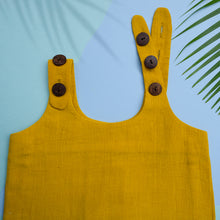 Load image into Gallery viewer, A beautiful deep yellow extendable shift dress kept on a blue background with leaf aside.
