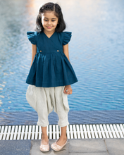 Load image into Gallery viewer, A young girl posing by wearing elegant blue flutter sleeve top and cream balloon pant with blur background.
