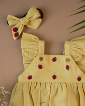 Load image into Gallery viewer, A cute romper with some strawberry embroidery on it with matching hair accessory, some leaf and flower aside.
