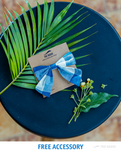 Load image into Gallery viewer, A beautiful bow hair accessory kept upon a blue plate and leaf with some flower aside.
